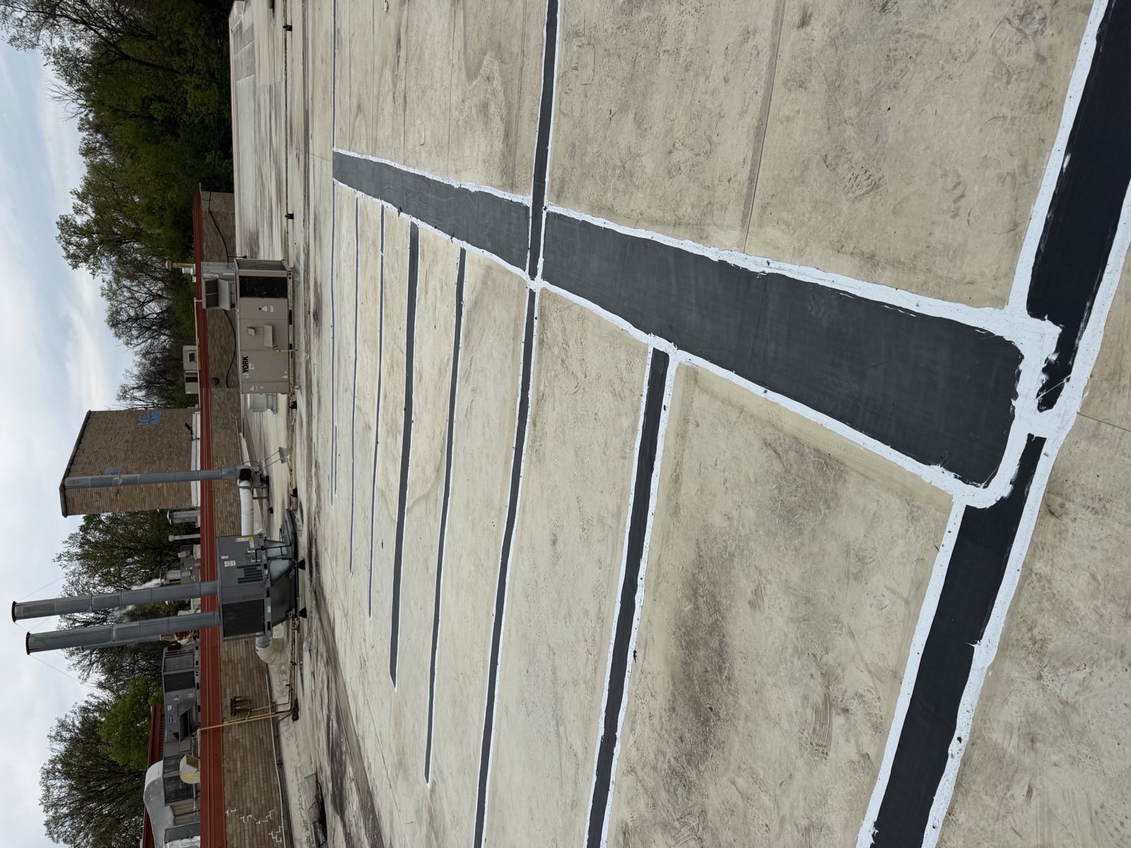 Aging commercial flat roof with patched seams on a Green Attic re-roofing project in Morton Grove